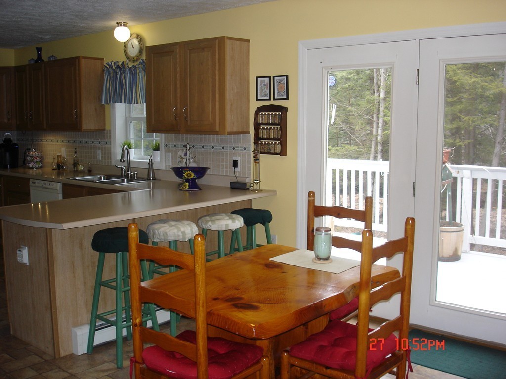 30 Bluefield Road Ashburnham, MA 01430 - Photo 8 of 30 a kitchen that has a table chairs in it and wooden floors