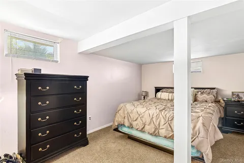 a bedroom with two beds and a dresser