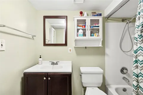 a bathroom with a sink mirror and toilet