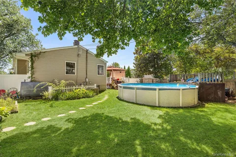 a view of a backyard with swimming pool