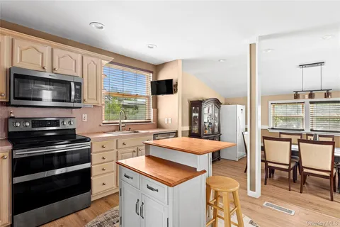 a kitchen with a stove a sink and a microwave