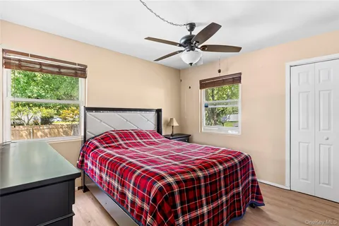 a bedroom with a large bed and a window