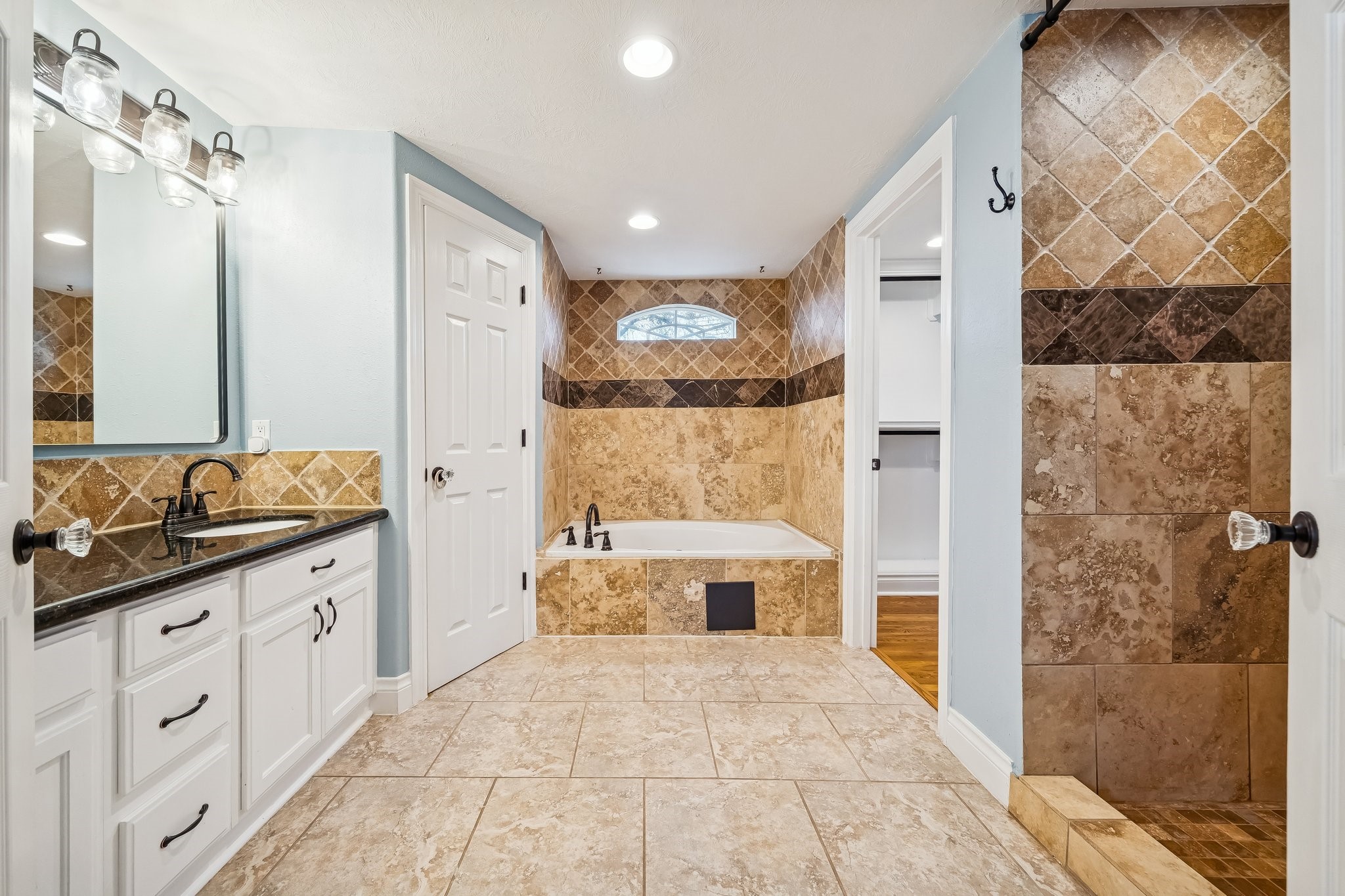 5309 Palmer Street Houston, TX 77004 - Photo 32 of 42 a bathroom with a double vanity sink a toilet a mirror and shower