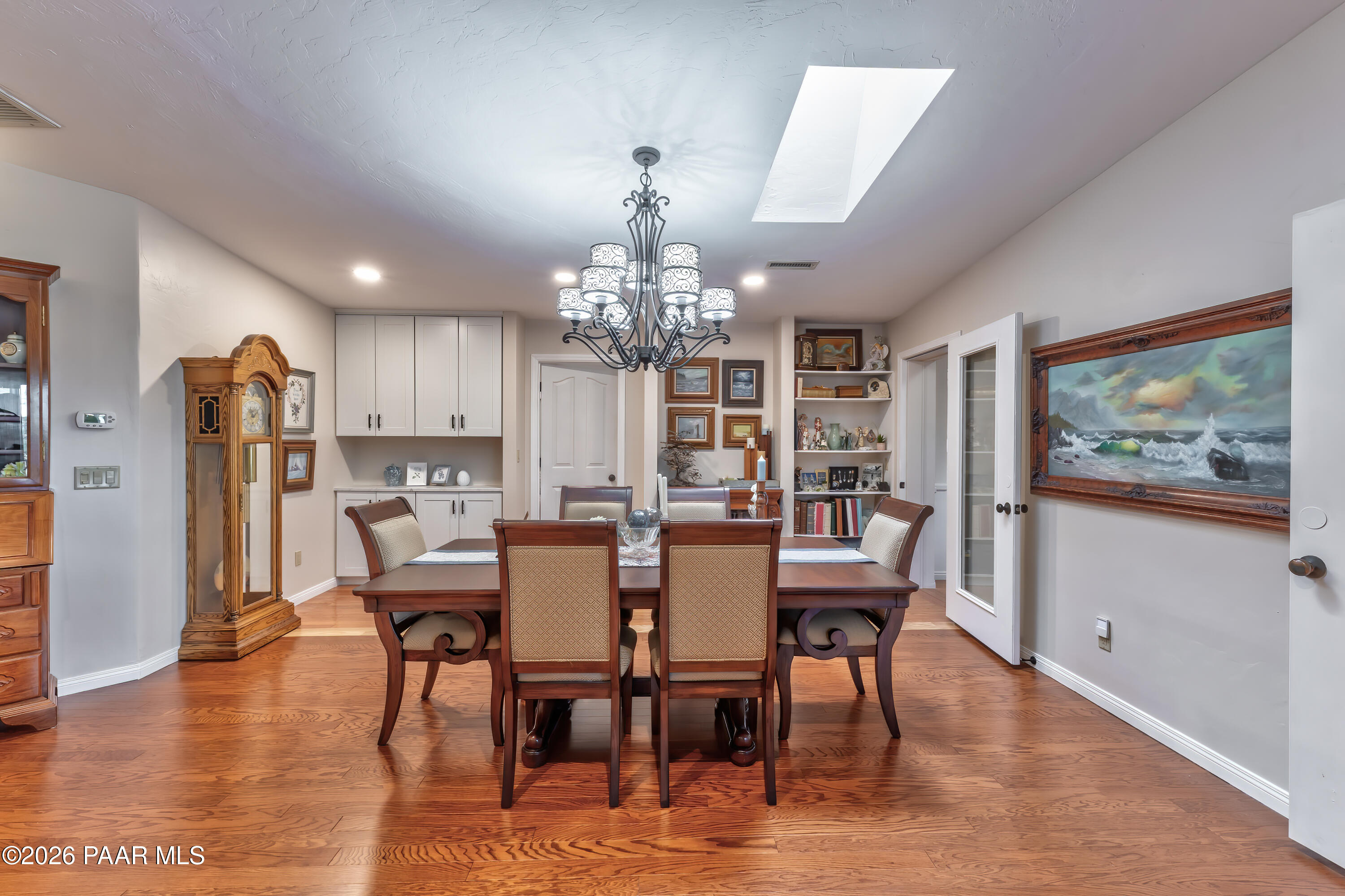 2405 North Williamson Valley Road Prescott, AZ 86305 - Photo 25 of 79 a view of a dining room with furniture a chandelier and wooden floor