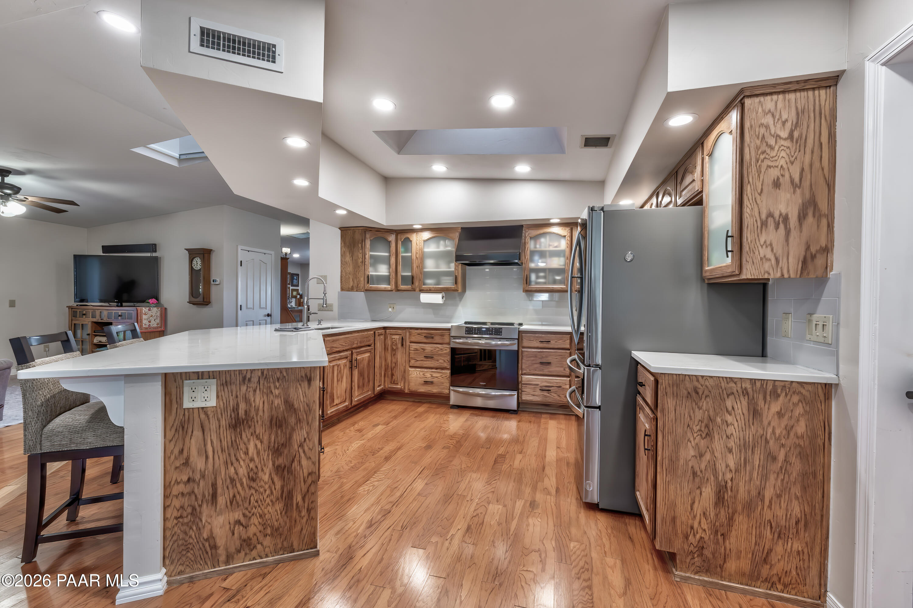 2405 North Williamson Valley Road Prescott, AZ 86305 - Photo 45 of 79 a large kitchen with stainless steel appliances a large counter top a stove and a wooden floors