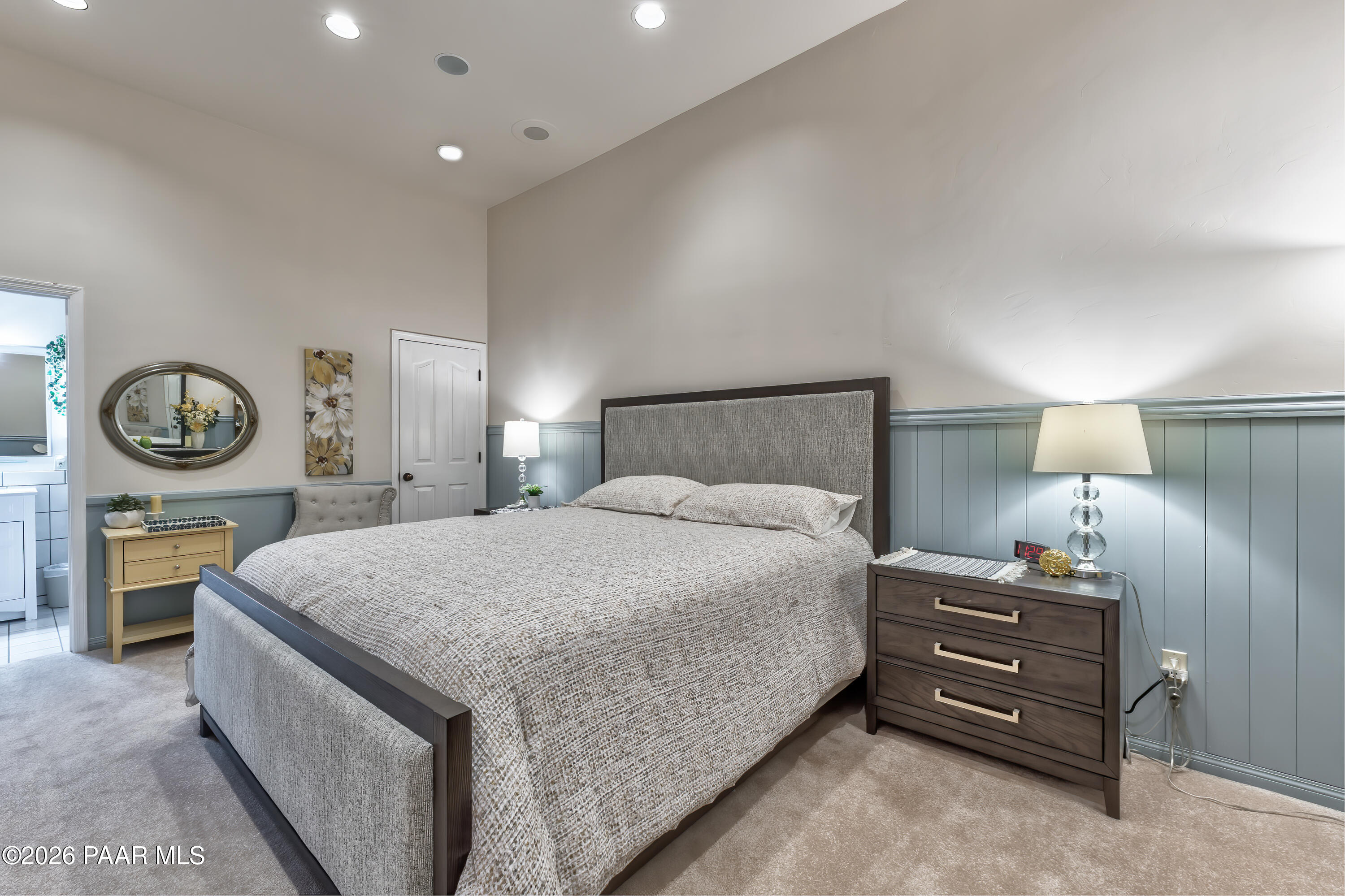 2405 North Williamson Valley Road Prescott, AZ 86305 - Photo 50 of 79 a bedroom with a bed a chandelier and a table