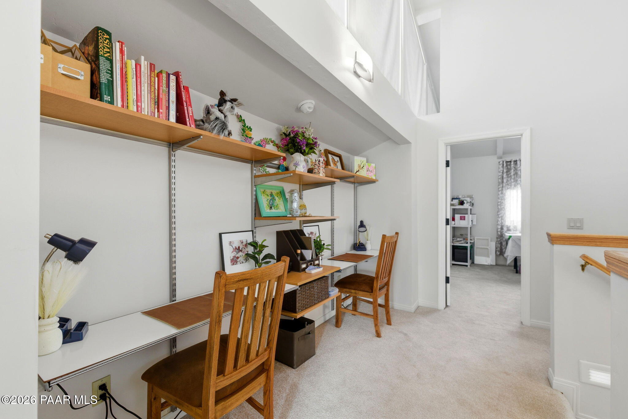 2405 North Williamson Valley Road Prescott, AZ 86305 - Photo 56 of 79 a view of a dining room with furniture and a book shelf
