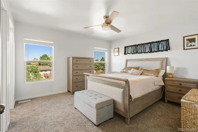 a bedroom with a bed a dresser and a window