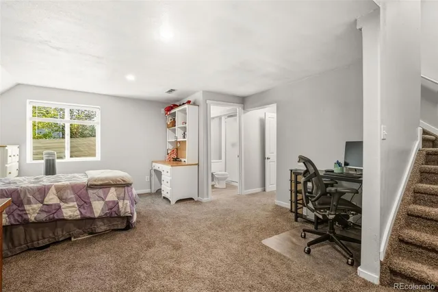 a bedroom with furniture and a window