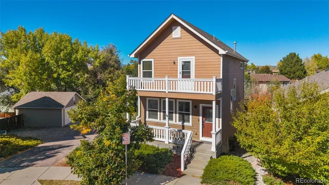 a view of house with yard and sitting area