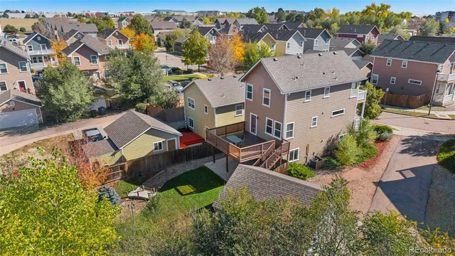 an aerial view of a house with a yard and lake view