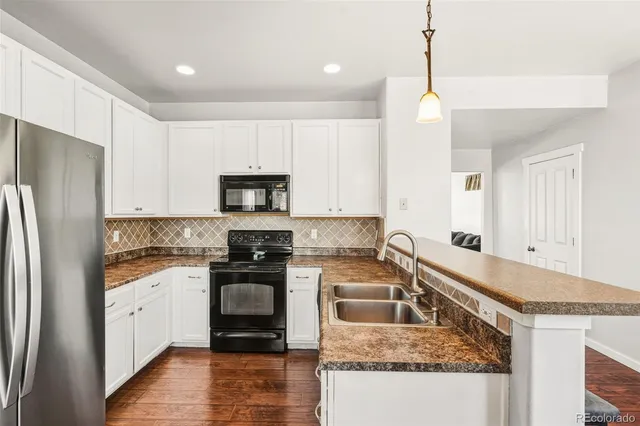 a kitchen with a sink stove and refrigerator