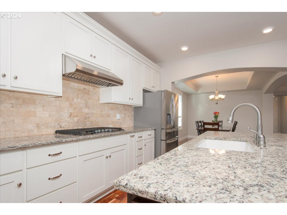 756 North 47th Avenue Ridgefield, WA 98642 - Photo 12 of 42 a kitchen with stainless steel appliances kitchen island granite countertop a sink and cabinets