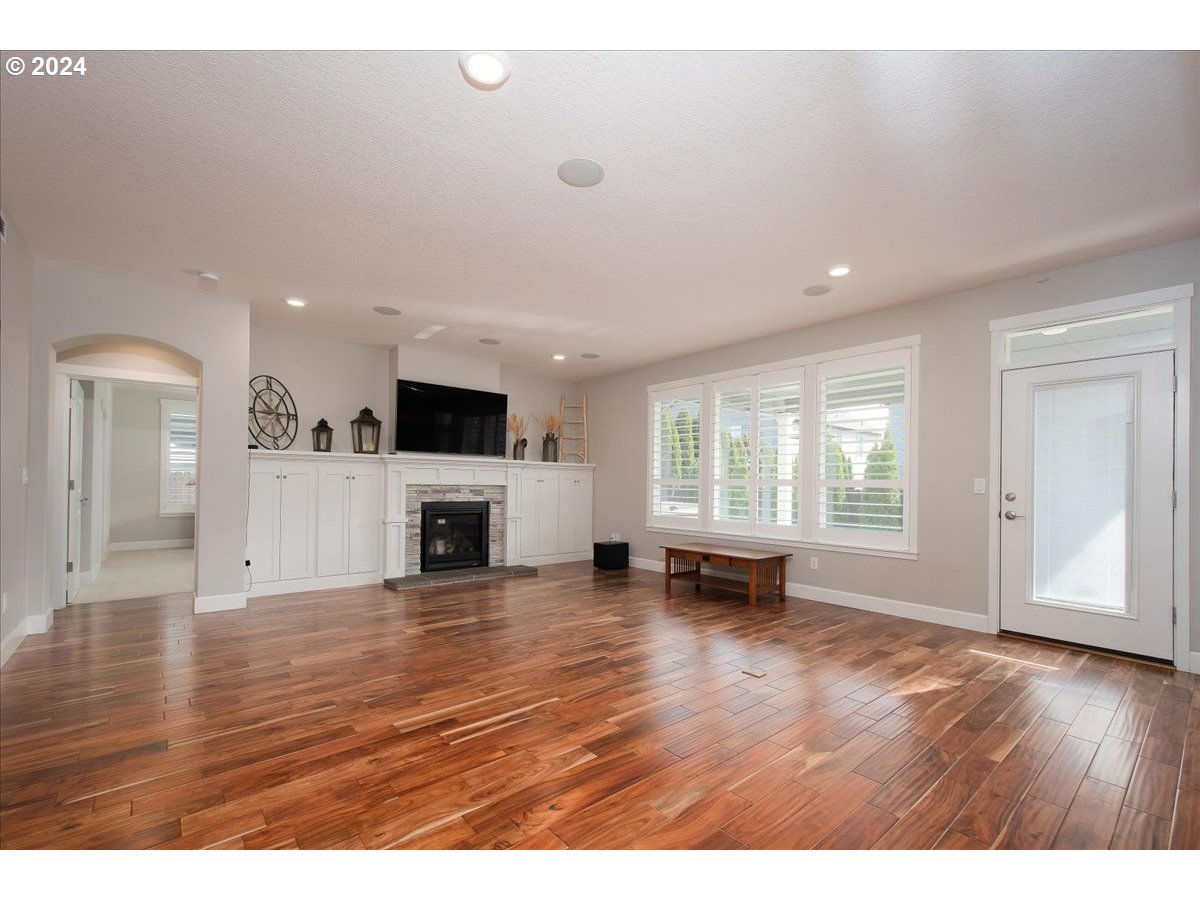 756 North 47th Avenue Ridgefield, WA 98642 - Photo 15 of 42 a view of empty room with wooden floor and fireplace