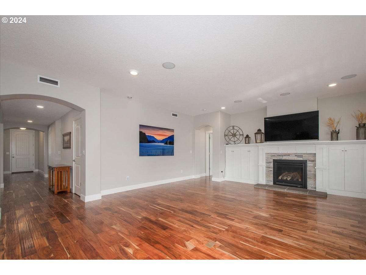 756 North 47th Avenue Ridgefield, WA 98642 - Photo 17 of 42 a view of empty room with wooden floor and fireplace