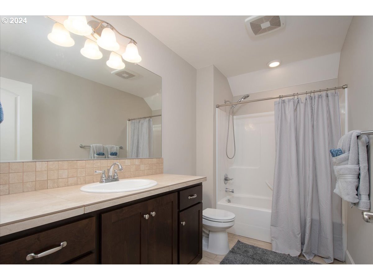 756 North 47th Avenue Ridgefield, WA 98642 - Photo 33 of 42 a bathroom with a double vanity sink toilet mirror and shower