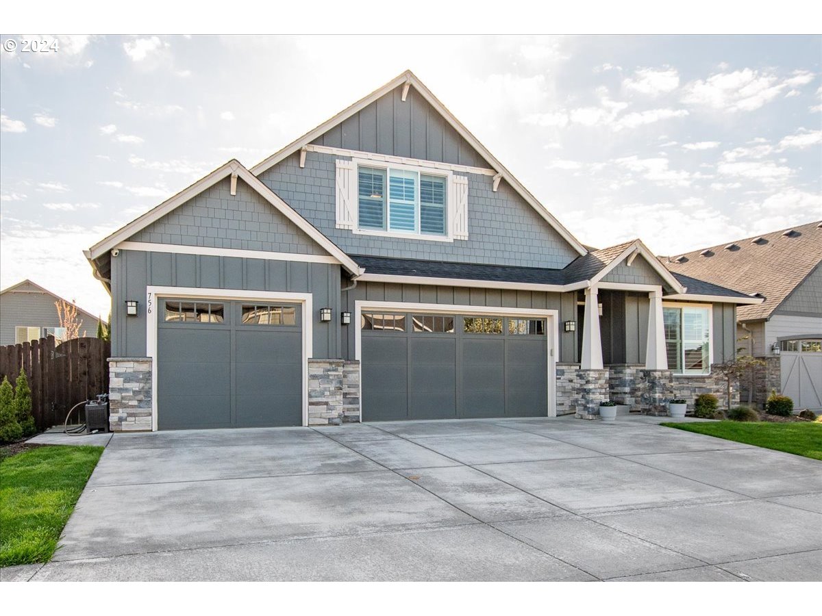 756 North 47th Avenue Ridgefield, WA 98642 - Photo 41 of 42 a front view of a house with a yard and garage