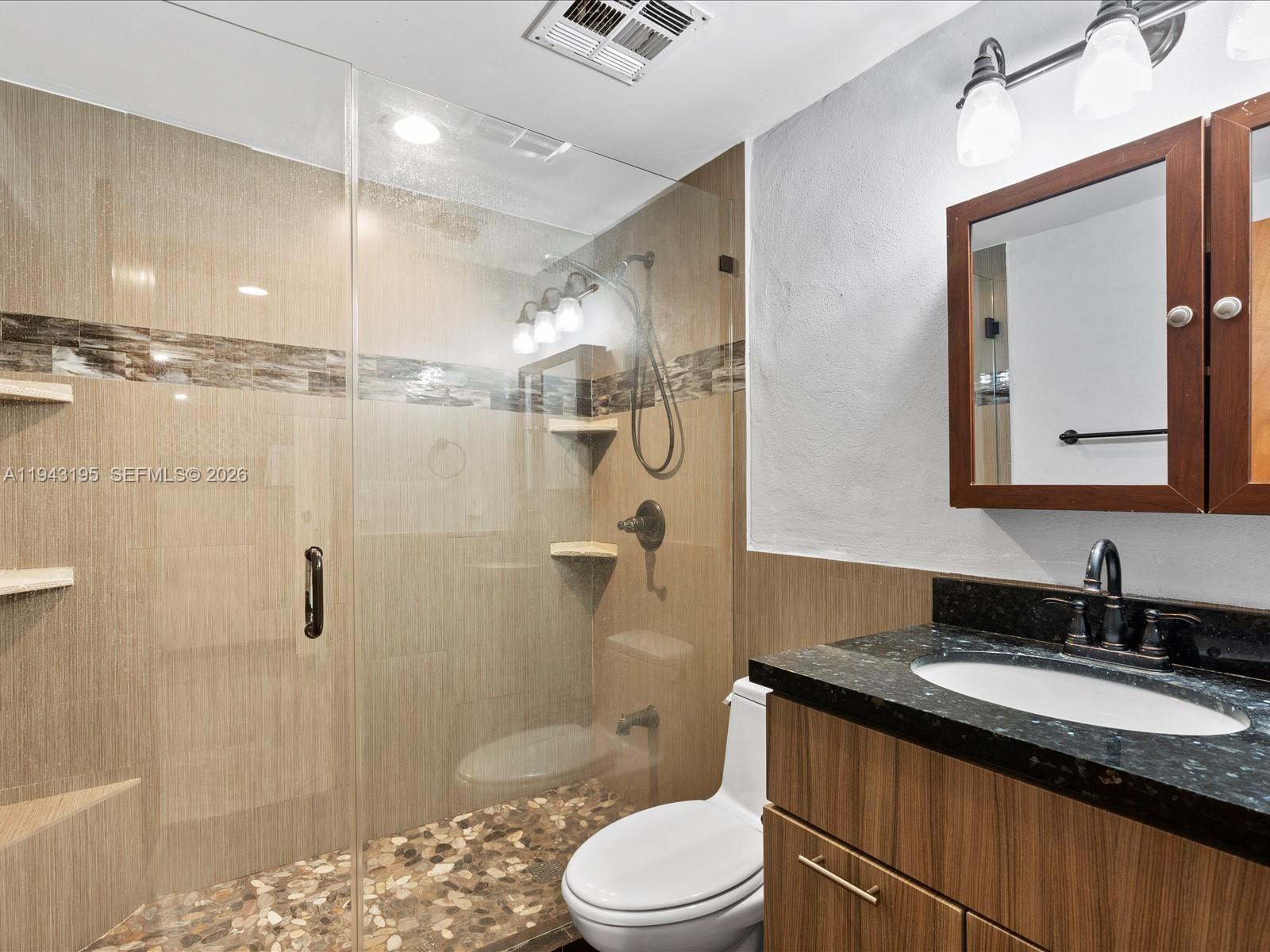 8840 Southwest 50th Terrace Miami, FL 33165 - Photo 15 of 20 a bathroom with a granite countertop sink toilet and shower