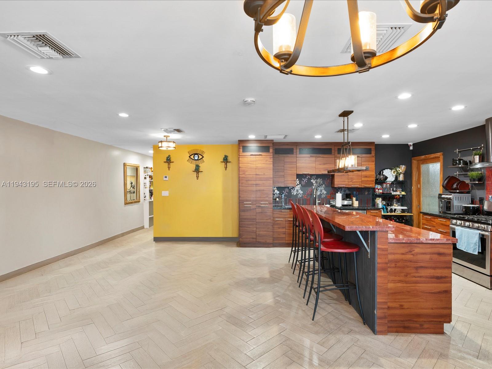 8840 Southwest 50th Terrace Miami, FL 33165 - Photo 6 of 20 a view of a kitchen with kitchen island dining table and a chandelier