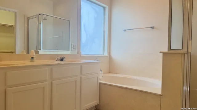 a bathroom with a bathtub and a sink