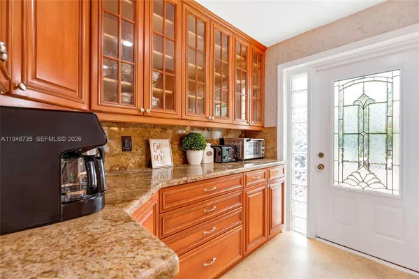 a bathroom with a granite countertop sink and a large mirror