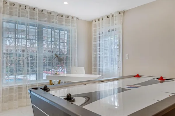 a view of a bedroom with cabinet and mirror