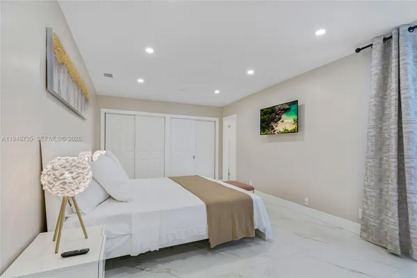 a bedroom with a bed and a chandelier