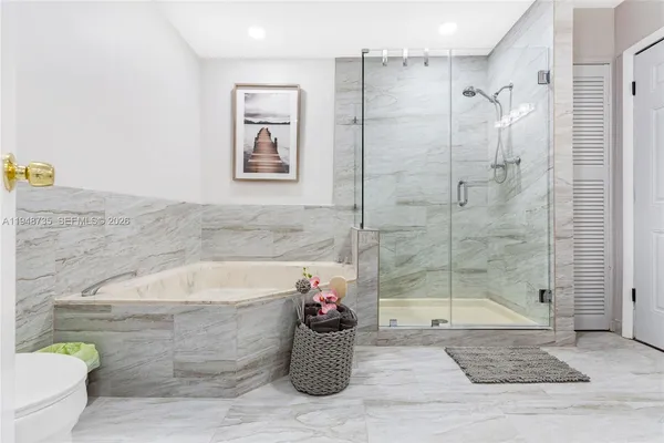 a bathroom with a sink mirror toilet and bathtub