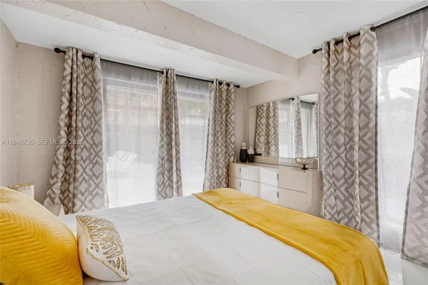 a bedroom with a bed and painting on the wall