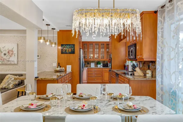 a kitchen with stainless steel appliances granite countertop a refrigerator and cabinets