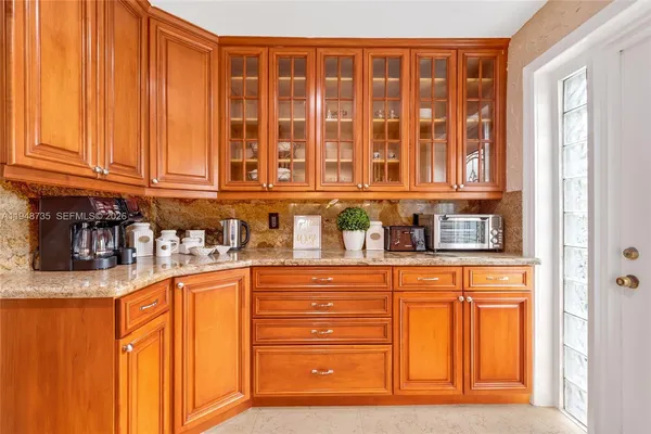 a kitchen with stainless steel appliances granite countertop a refrigerator and a stove top oven