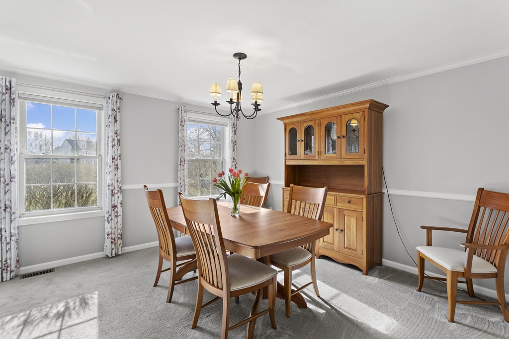 66 Clover Hill Circle Tyngsborough, MA 01879 - Photo 15 of 42 a view of a dining room with furniture window and outside view