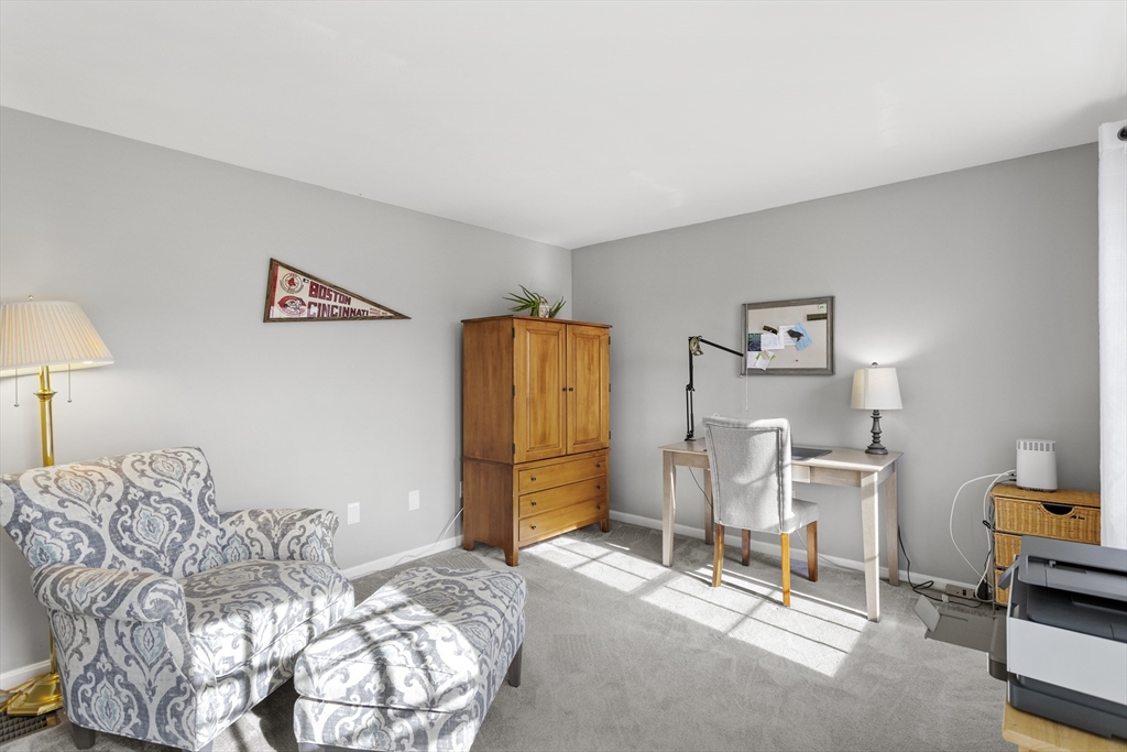 66 Clover Hill Circle Tyngsborough, MA 01879 - Photo 16 of 42 a bedroom with a bed a chair and painting on the wall