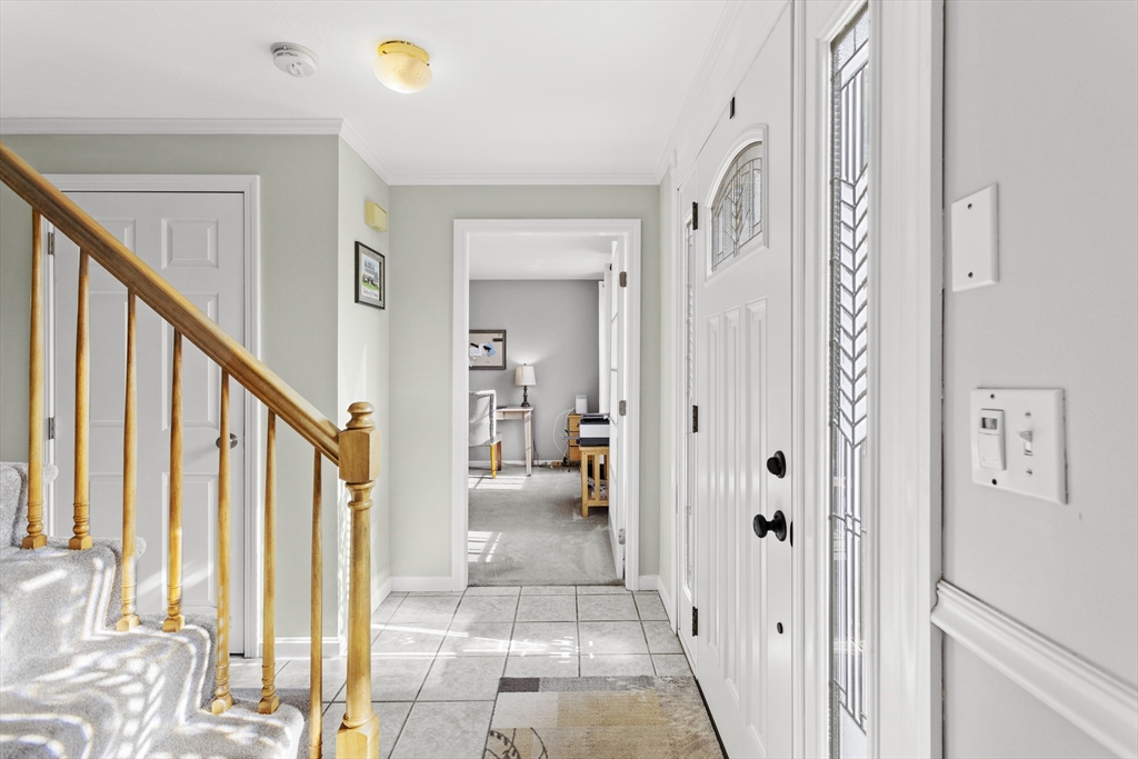 66 Clover Hill Circle Tyngsborough, MA 01879 - Photo 18 of 42 a view of an entryway with wooden floor and a livingroom