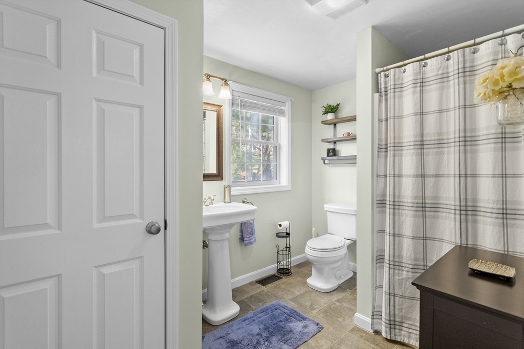 66 Clover Hill Circle Tyngsborough, MA 01879 - Photo 19 of 42 a bathroom with a toilet sink and a shower