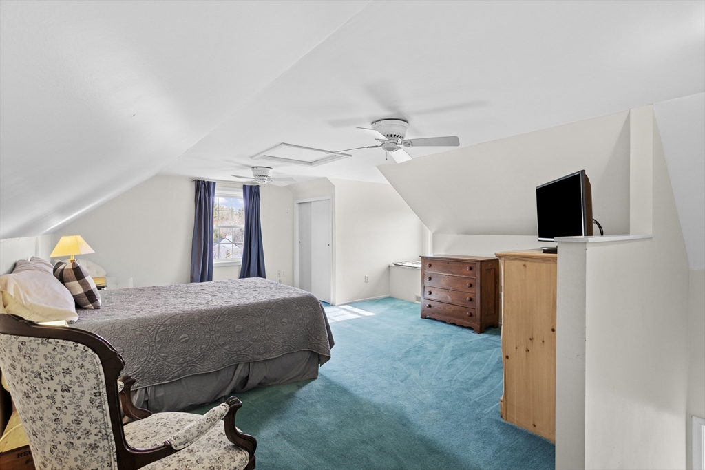 66 Clover Hill Circle Tyngsborough, MA 01879 - Photo 30 of 42 a room with a bed and flat screen tv