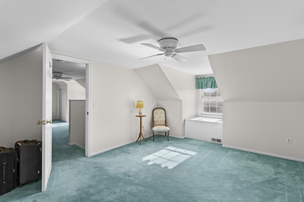 66 Clover Hill Circle Tyngsborough, MA 01879 - Photo 32 of 42 a view of a livingroom with a furniture ceiling fan and window