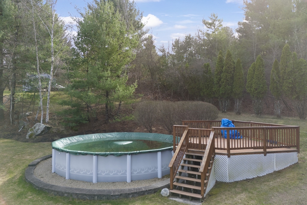 66 Clover Hill Circle Tyngsborough, MA 01879 - Photo 35 of 42 a view of a swimming pool with a corridor