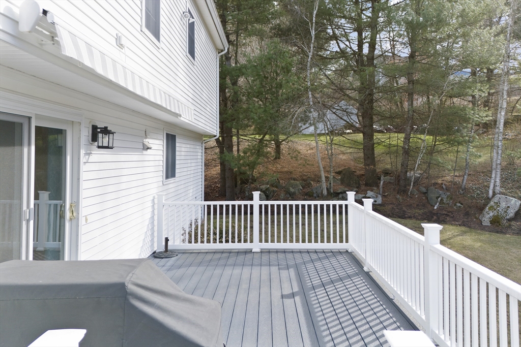 66 Clover Hill Circle Tyngsborough, MA 01879 - Photo 36 of 42 a view of a wooden roof deck