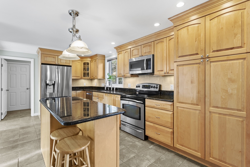 66 Clover Hill Circle Tyngsborough, MA 01879 - Photo 4 of 42 a kitchen with stainless steel appliances granite countertop a refrigerator a stove a sink a oven and a refrigerator