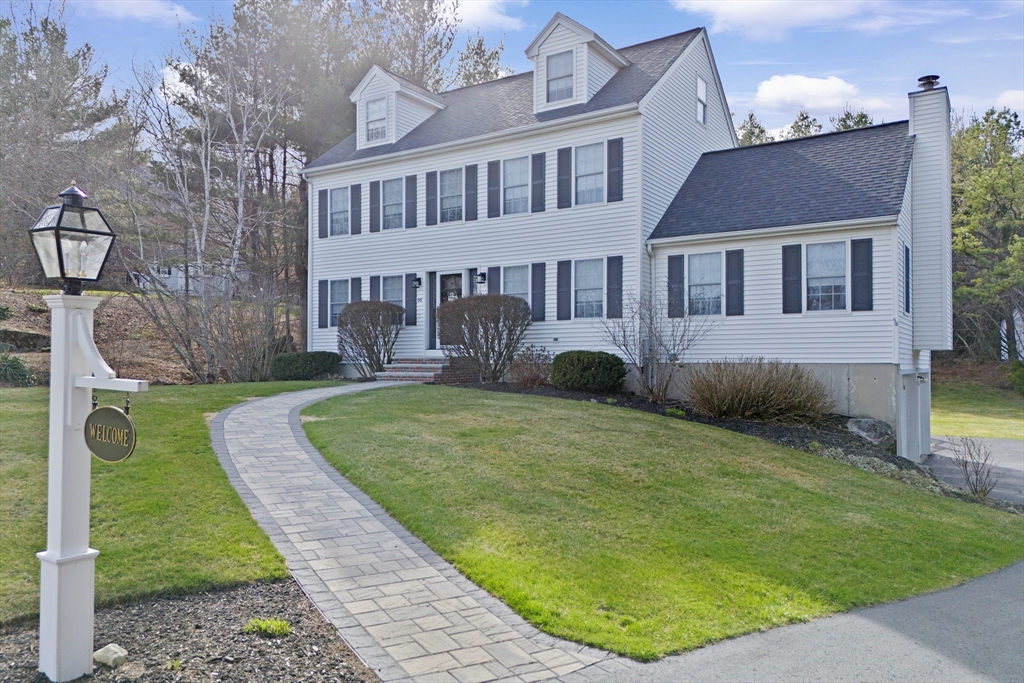 66 Clover Hill Circle Tyngsborough, MA 01879 - Photo 42 of 42 a front view of a house with garden