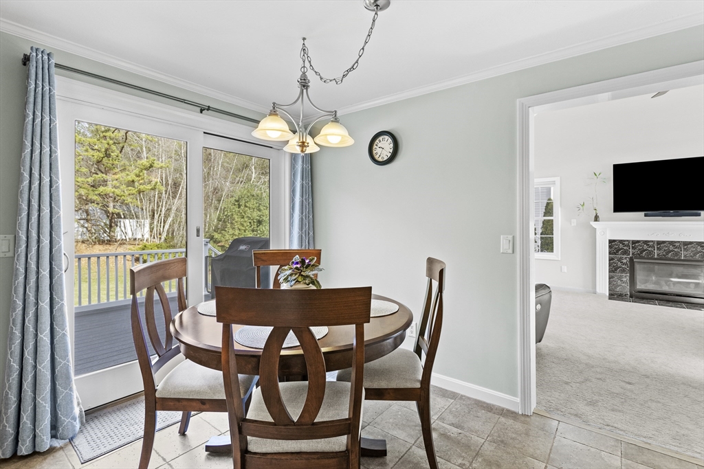 66 Clover Hill Circle Tyngsborough, MA 01879 - Photo 8 of 42 a view of a dining room with furniture window and wooden floor