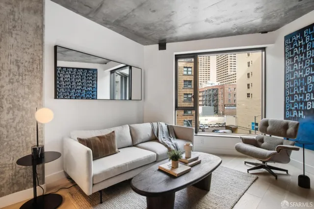 a living room with furniture and a large window