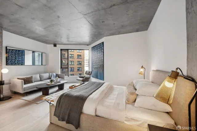 a bedroom with a bed couch and window