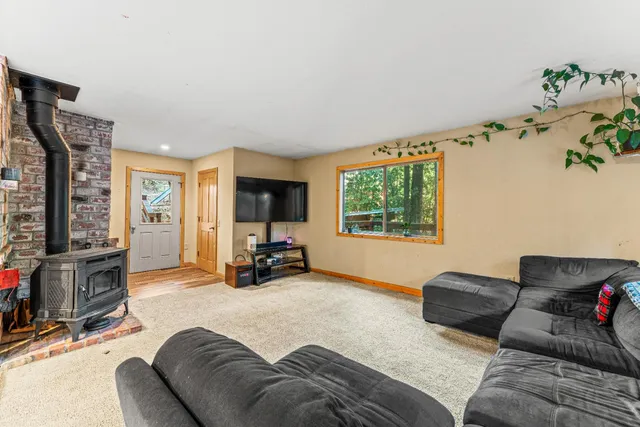 a living room with furniture large window and flat screen tv