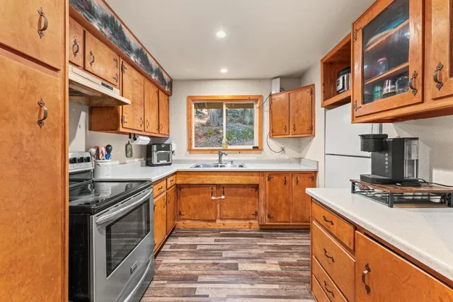 a kitchen with stainless steel appliances granite countertop a stove and a sink