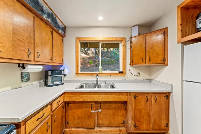 a kitchen with stainless steel appliances granite countertop sink and cabinets