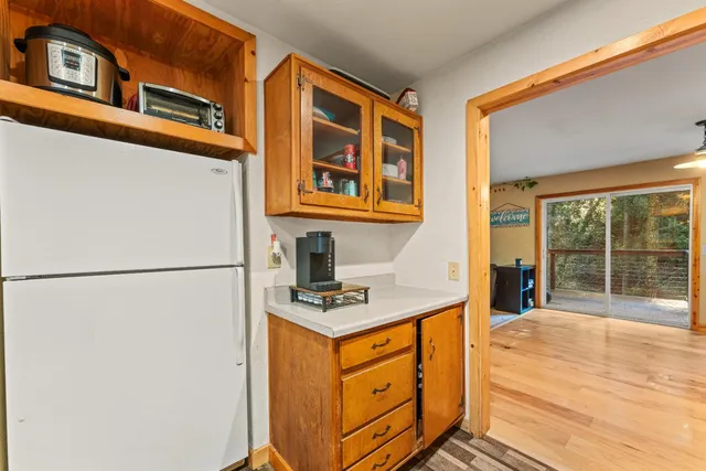 a view of kitchen with stainless steel appliances refrigerator and stove