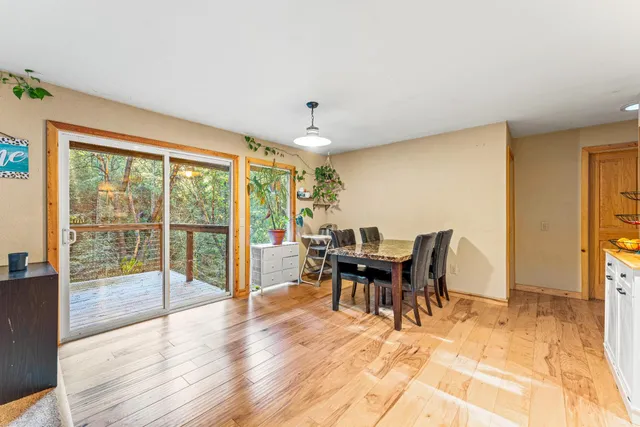 a dining room with furniture a chandelier and wooden floor