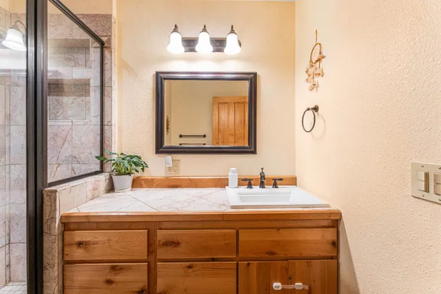 a bathroom with a sink and a mirror